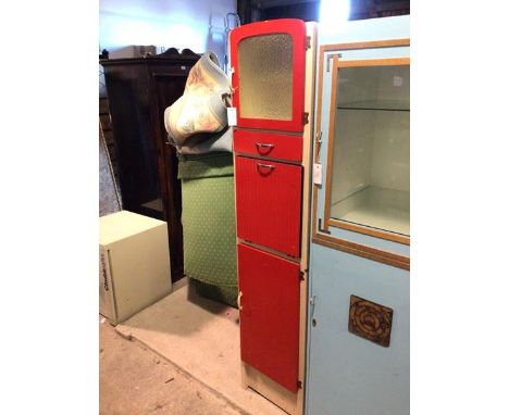 A vintage 1950s/60s tall kitchen cabinet, painted white and red, the top cupboard with glass panelled door above a shelf, wit