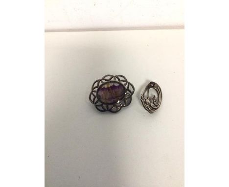 A silver brooch with oval bluejohn panel (4cm) and another silver brooch with floral design (2)