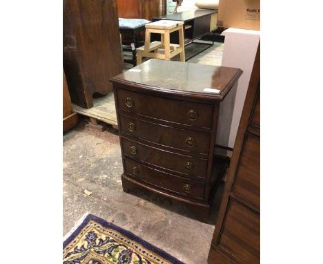 A small Georgian inspired reproduction bow front chest of drawers, the rectangular top with moulded edge above four drawers, 