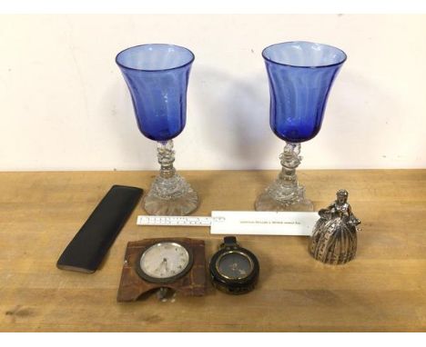 A mixed lot including two wine glasses with blue and clear glass (each: 21cm), a metal bell of a lady, compass, travelling cl