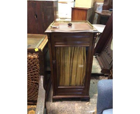 An Edwardian sheet music cabinet, with a pierced three quarter gallery top, with moulded serpentine fronted edge, above a gla