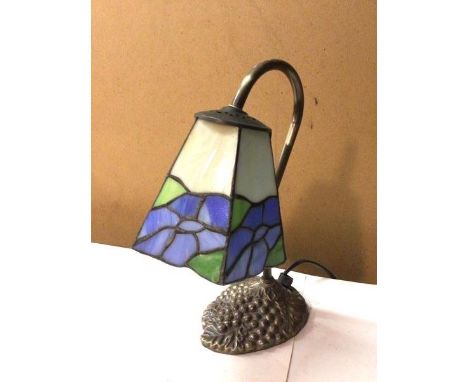 A Tiffany style desk lamp with faceted glass shade, on leaf and fruit base (27cm)