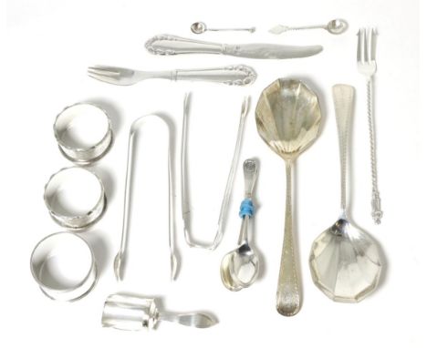 A mixed group of silver items including napkin rings; sugar tongs; Georg Jensen knife and fork; caddy shovel etc 