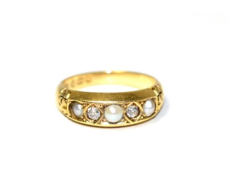An 18 carat gold pearl and diamond ring, three pearls spaced by old cut diamonds in kite settings, to a carved shank, total e