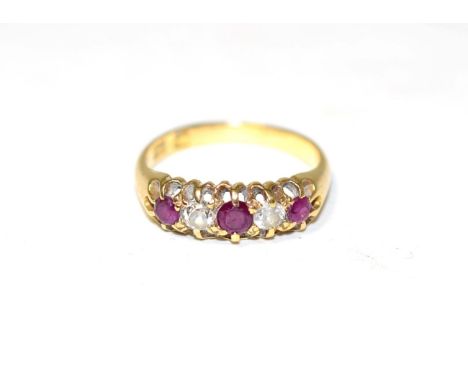 A ruby and diamond ring, three round cut rubies, spaced by old cut diamonds, to a carved setting, total estimated diamond wei