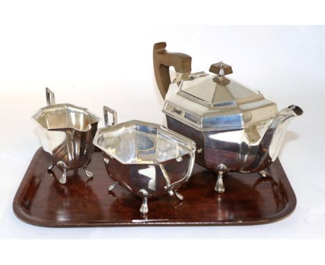 An Art Deco silver three piece tea service, Viners Ltd, Sheffield 1940, octagonal form on paw feet, teh teapot 26cm long, 29.