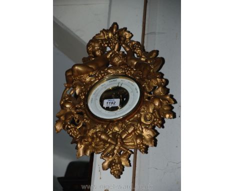 An ornate Barometer decorated with cherubs by E. Lennie Edinburgh.