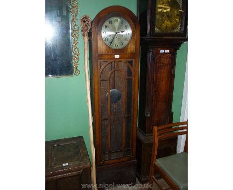 A 1930/40's Longcase Clock having three-train movement with arched Oak case generously glazed to the door. 16 1/4'' wide x 69