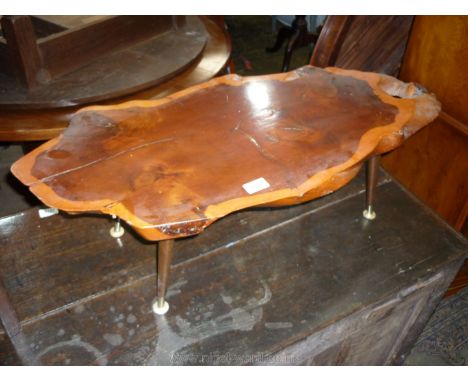 A Yew wood rustic tree-trunk slice Coffee Table. 33 3/4'' x 15'' x 10 1/2'' high.