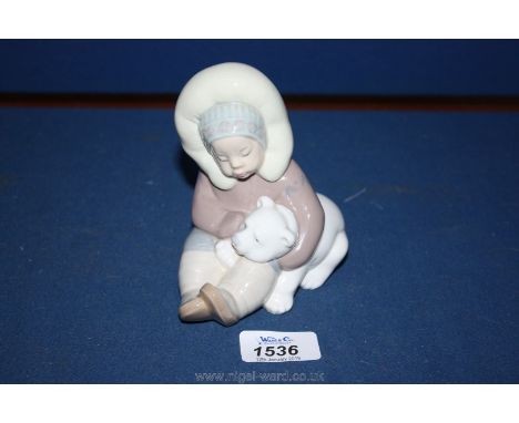 A Lladro figure of an Inuit Eskimo child with Bear.