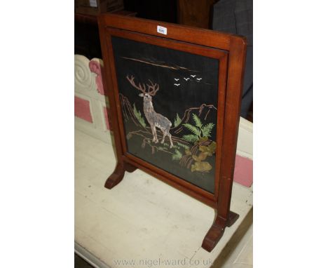 A Mahogany framed firescreen with needlework depiction of a Stag in the Highlands amidst rocky outcrops, ferns, etc., 23 1/4"