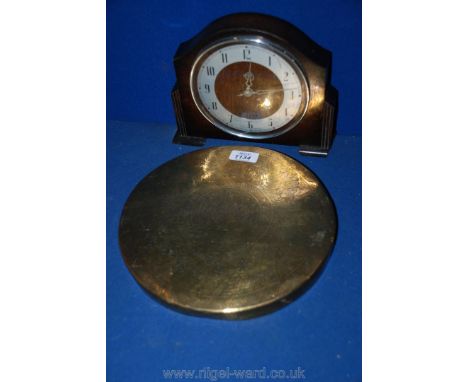 A brass gong and a mantle clock.