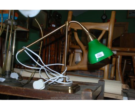 A Brass desk Lamp with green glass shade.