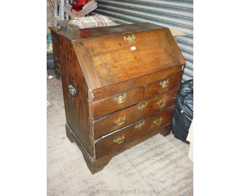 A circa 1800 Oak Bureau, the fall front revealing an interior with shelf and pigeonholes with two long and two short drawers 