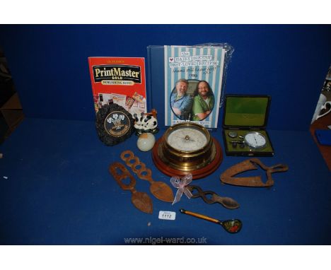 A quantity of miscellanea including circular barometer, onyx egg, small cow door stop, wooden love spoons and a boxed oil pre