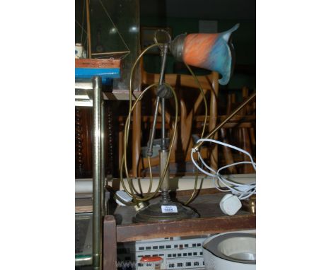 A Brass table Lamp with orange and blue glass shade.