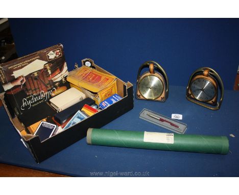 A box of miscellaneous items including playing cards, barometer and clock set in stirrups, reproduction map of Herefordshire 