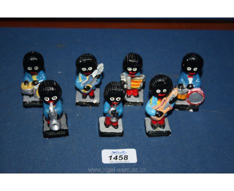 Seven Robertson's Golly figures including Accordion, drummers, guitars, saxophone and trumpet.