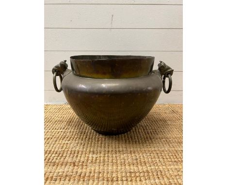 An Indian brass pot with elephants head ring handles (H34cm Dia41cm)