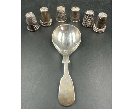 A silver caddy spoon and six silver thimbles, various hallmarks and makers