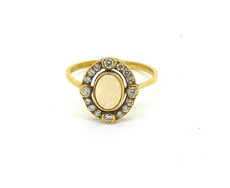 Yellow metal ring with an oval opal set inside an oval diamond set halo. Opal estimated to be 0.50 carats. Marked 18CT Size O