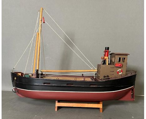 A wooden painted scale model of a Clyde Puffer on stand 