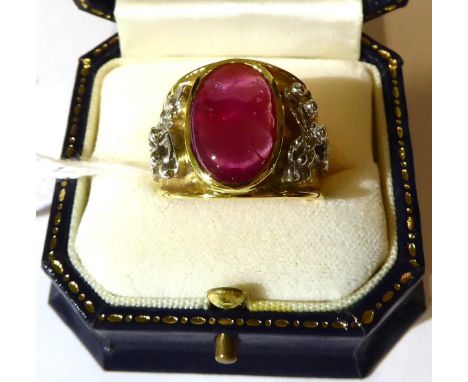 An 18 carat two colour gold glass filled cabochon ruby ring, oval cut in a rubbed over settings, to a carved tapering shank w