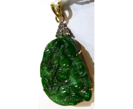 An 18 carat gold jade and diamond pendant, a carved jade plaque depicting birds and fruit to a bail set with three round bril