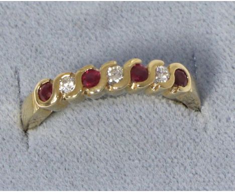 A 9 carat gold ruby and diamond half hoop ring, total estimated diamond weight 0.15 carat approximately, finger size N The ri