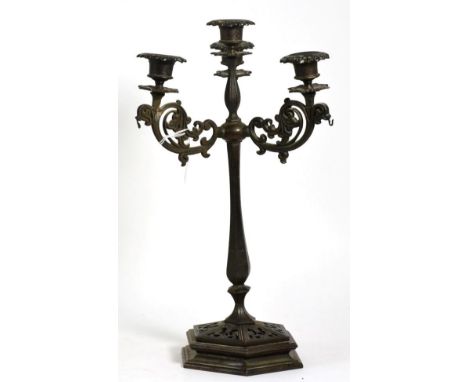 A 19th century cast iron candelabrum, three scroll arms, four light, hexagonal pierced base, 42cm in height; together with a 