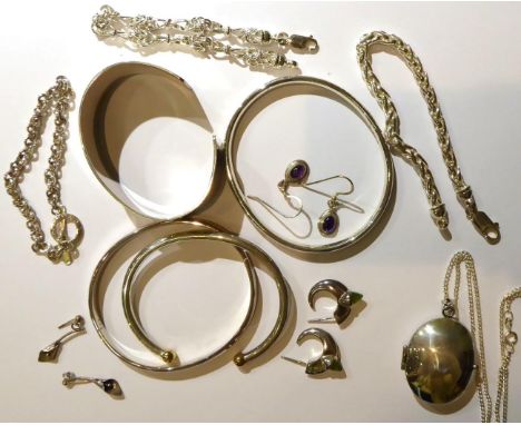 Four silver bangles, three silver bracelets, a silver locket on chain, a pair of silver peridot set earrings, a pair of ameth