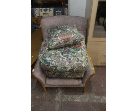 A PARKER KNOLL ARM CHAIR TOGETHER WITH A FLORAL PATTERNED FOOT STOOL AND MATCHING CUSHION 