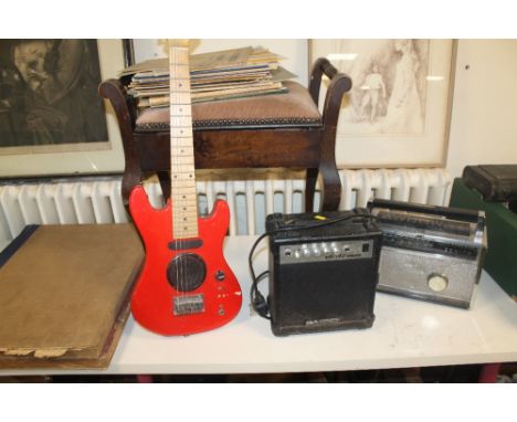 A CHILD'S GUITAR TOGETHER WITH AN AMP, PIANO STOOL, SHEET MUSIC, ETC 