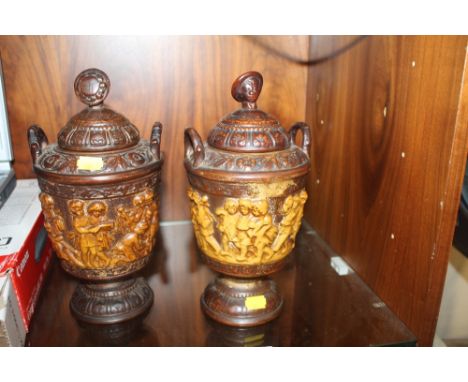 A PAIR OF DECORATIVE CERAMIC URNS 