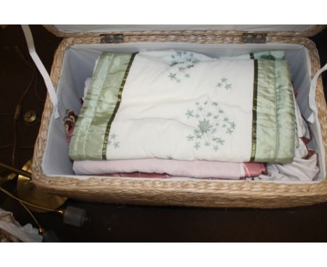 A WICKER BASKET CONTAINING A QUANTITY OF CURTAINS, ETC