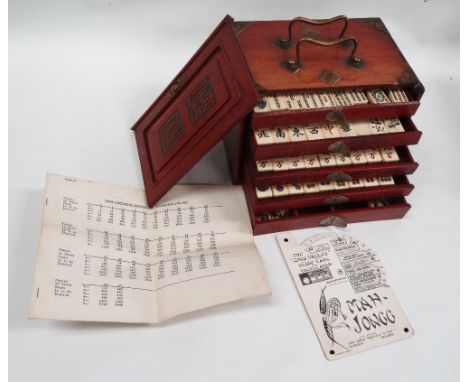 Mahjong set - A mahogany brass bound box with five drawers, the bone pieces mounted on bamboo, box height 16cm, width 23cm, d