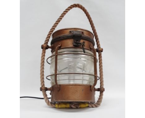 A Davey London masthead lamp - A metal and brass white all round masthead light, converted to electricity, with rope hanging 