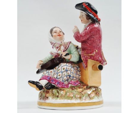 A late 19th/early 20th century continental porcelain figure - A figural group of a lady musician and a gentleman holding a la