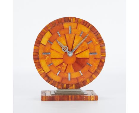 German Art Deco table clock, ca. 1930-1940. Round amber segmented dial resting on a similar rectangular base. Nickel-plated h