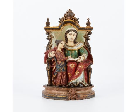 Polychromed and carved wooden santos of a mother and daughter reading a Bible or book. Seated on a throne.Provenance: From th