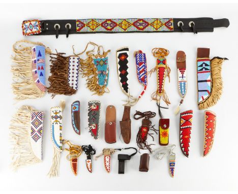 Collection of 25 Native American style leather and beadwork sheaths, holsters, and one belt. Many with fringed hide along one