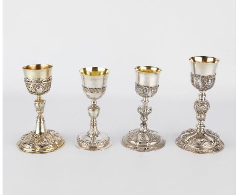 Group of four continental silver chalices, each with elaborate scrolling decoration in low relief throughout. Each with impre