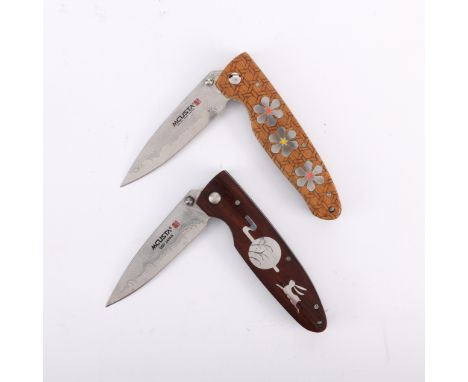 Mcusta, Seki, Japan. Group of two limited edition folding knives. Each with a wood encasement lined and inset with stainless 