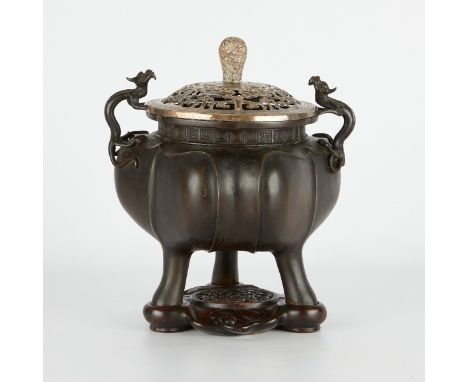 A very well cast 19th century Chinese bronze censer with a custom carved wooden stand and a later pierced lid, silver plated 