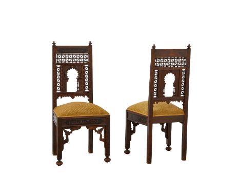 Pair of Syrian carved wood side chairs with mashrabiya style latticework backs. The back and skirting are incised with Arabic