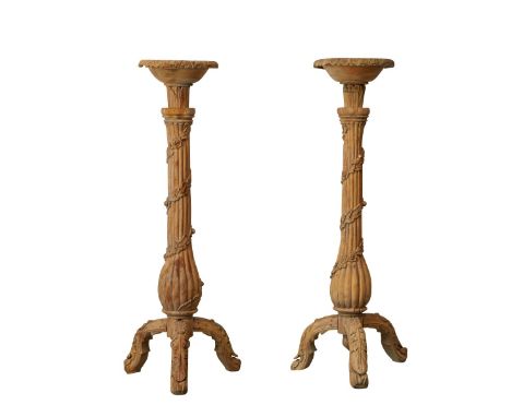 Pair of large carved wooden tripod plinths or candle sticks. With a fluted body wrapped in a curling swag of vines and flower