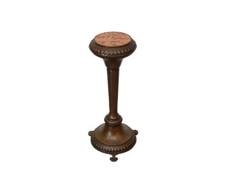 Victorian bronze stand with a marble inlaid top. The fluted stand rests on a rounded base with three claw feet. With teardrop