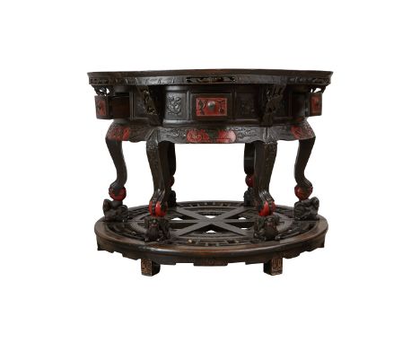 Chinese round carved wood table with drawers, 19th century. Carved with floral and foliate designs, with red decoration. Curr