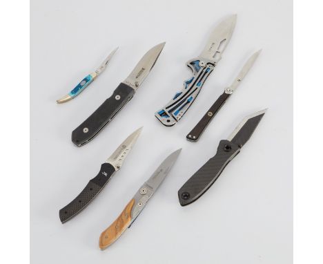 Group of seven folding knives including:One NIRK-Tighe 5250 CRKT folding knife featuring a blue and gray stainless steel hand