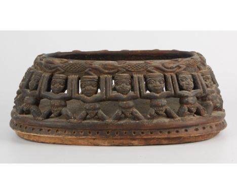 Carved and pierced African wooden basket or vessel, possibly created in Cameroon. With repeating figures and lizards along th